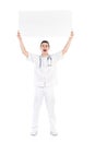 Shouting male doctor holding empty placard over his head Royalty Free Stock Photo