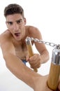 Shouting man holding nunchaku