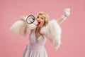 Portrait of young woman in white dress on coral pink background. Female model as a legendary actress. Pin up. Concept of