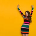 Shouting Woman In Striped Dress With Arms Raised Royalty Free Stock Photo
