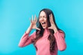 Shouting young angry woman isolated on blue background