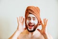 shouts, scared and messy man applying beauty facial mask looking at camera Royalty Free Stock Photo