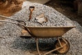 Shovel with cement cart and gravel black rock on construction site for background. Construction starts with planning, design, and Royalty Free Stock Photo