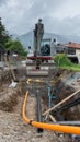 Shovel excavator digging gas and power pipes Royalty Free Stock Photo