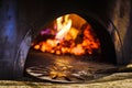 Shovel in front of traditional italian brick pizza oven Royalty Free Stock Photo