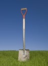 Shovel in green grass Royalty Free Stock Photo