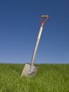 Shovel in green grass Royalty Free Stock Photo