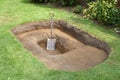 Shovel in hole for pond