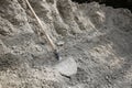 Shovel lying on a pile of construction material