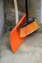 Shovel and an orange broom