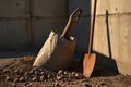 Shovel and Pickaxe Leaning Against a Wooden Structure on a Construction Site Royalty Free Stock Photo