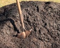 Shovel in pile of topsoil