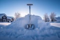 shovel stuck in a large snow drift