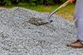 shovel throw stones into gabione