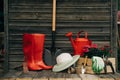 Shovel, watering can, hat, rubber boots, box of flowers, gloves and garden tools Royalty Free Stock Photo