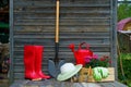 Shovel, watering can, hat, rubber boots, box of flowers, gloves and garden tools Royalty Free Stock Photo