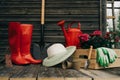 Shovel, watering can, hat, rubber boots, box of flowers, gloves and garden tools Royalty Free Stock Photo