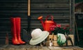 Shovel, watering can, hat, rubber boots, box of flowers, gloves and garden tools Royalty Free Stock Photo