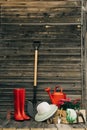 Shovel, watering can, hat, rubber boots, box of flowers, gloves and garden tools Royalty Free Stock Photo