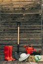 Shovel, watering can, hat, rubber boots, box of flowers, gloves and garden tools Royalty Free Stock Photo