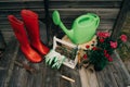 Shovel, watering can, hat, rubber boots, box of flowers, gloves and garden tools Royalty Free Stock Photo
