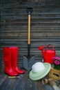 Shovel, watering can, hat, rubber boots, box of flowers, gloves and garden tools Royalty Free Stock Photo