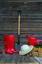 Shovel, watering can, hat, rubber boots, box of flowers, gloves and garden tools Royalty Free Stock Photo