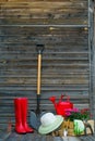 Shovel, watering can, hat, rubber boots, box of flowers, gloves and garden tools Royalty Free Stock Photo