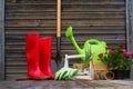 Shovel, watering can, hat, rubber boots, box of flowers, gloves and garden tools Royalty Free Stock Photo