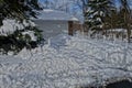 Shoveled driveway in front of a garage after a big snowy storm