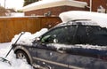 Shoveling Deep Snow In Driveway of House With Car Half Buried