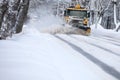 Shoveling snow from the road and blowing snow, snowy roads on a winter day, close-up Royalty Free Stock Photo