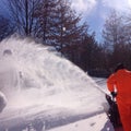 Man blowing snow after winter storm Royalty Free Stock Photo