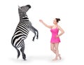 Clown girl performing with Zebra in circus show.