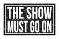 THE SHOW MUST GO ON, words on black rectangle stamp sign