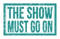 THE SHOW MUST GO ON, words on blue rectangle stamp sign