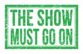 THE SHOW MUST GO ON, words on green rectangle stamp sign