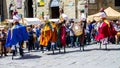 Show of stilt walkers in the street surrounded by the spectators