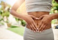 Show your body some love. a sporty young woman making a heart with her hands on her stomach. Royalty Free Stock Photo