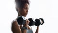 Show yourself how strong you are. a young woman working out with dumbbells in a gym.