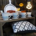 Showcase antique shop with porcelain cups and pillows.