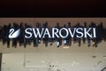 Showcase of a boutique of Swarovski jewelry. Swarovski - Austrian lead glass manufacturer. Swarovski swan symbol and logo on a