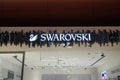 Showcase of a boutique of Swarovski jewelry. Swarovski - Austrian lead glass manufacturer. Swarovski swan symbol and logo on a