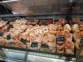 Showcase butcher closeup. A large assortment of meat, minced meat, offal in a butcher`s shop.