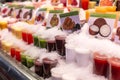 Showcase with different types of colorful cold juice and smoothie in the ice on the market in Barcelona, Catalonia Royalty Free Stock Photo