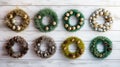 Showcase festive wreaths in a flat lay on a light wooden backdrop