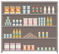 Showcase with groceries in the store. Fridge for cooling dairy products. Colored bottles and boxes Royalty Free Stock Photo