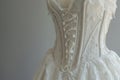 Showcase of the intricate beauty of a wedding dress featuring exposed corsetry with see-through lace inserts