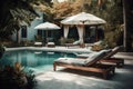 Showcase a luxurious pool area with all the amenities, such as cushy lounge chairs, umbrellas, and a bar with tropical drinks. The Royalty Free Stock Photo