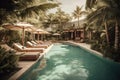 Showcase a luxurious pool area with all the amenities, such as cushy lounge chairs, umbrellas, and a bar with tropical drinks. The Royalty Free Stock Photo